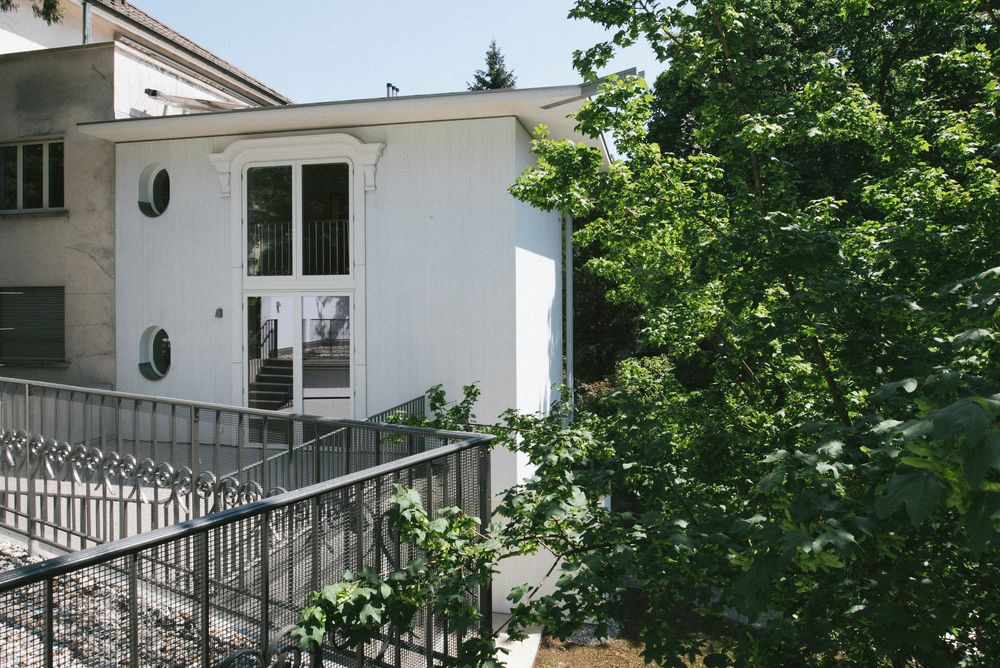 Hauseingang mit runden Fenstern und Treppe